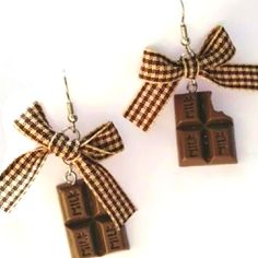 two pieces of chocolate tied together with bowknots on earwires,