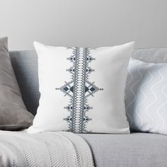 a black and white throw pillow sitting on top of a couch