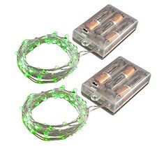 two batteries with green lights on them