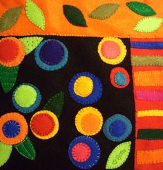 an orange and black blanket with colorful circles on it