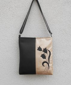 a black and gold purse hanging on a wall