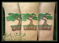 two tattoos with trees on the legs