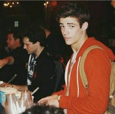 two young men are sitting at a table