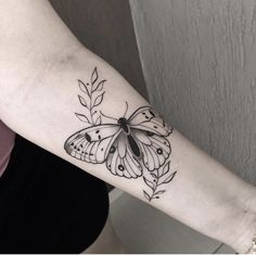 a woman's arm with a butterfly tattoo on the left side of her arm