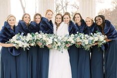 a bride and her bridal party posing for a photo in front of the lincoln memorial