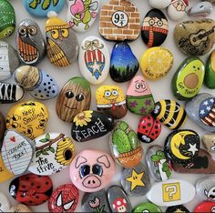 many different colored rocks with cartoon characters on them, all painted in different colors and sizes