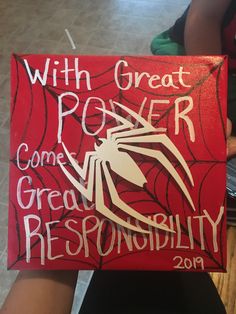 a person holding up a sign that says with great power come great repondility