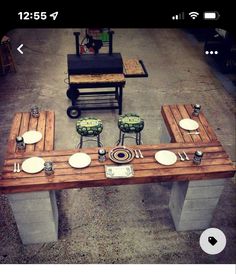 a table made out of pallet wood with plates and utensils on it