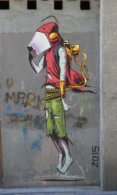 a painting on the side of a building shows a man with a backpack and large bag