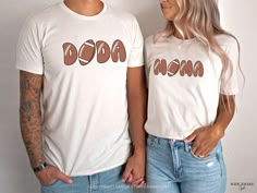 a man and woman standing next to each other wearing t - shirts with the word mom on them