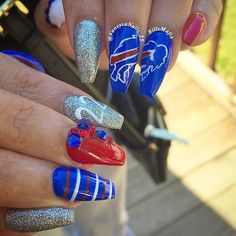 a person with blue and red nail polish on their nails