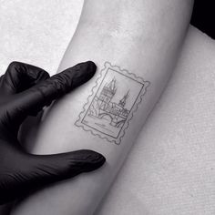 a woman's arm with a stamp on it that has a castle in it