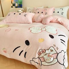 a hello kitty bed with pink sheets and pillows