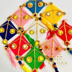 a group of colorful kites with tassels on them