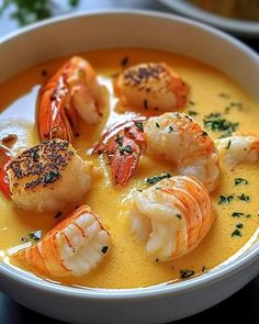 a white bowl filled with shrimp and cheese soup