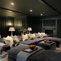 a living room filled with lots of couches and pillows on top of it's covers