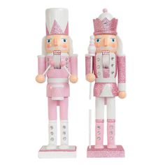 two pink and white nutcrackers are standing next to each other