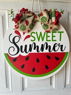 a watermelon sign hanging on the front door