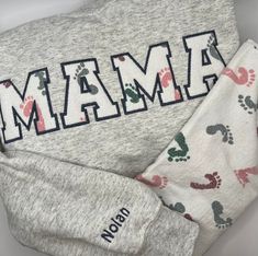 You will love our Custom MAMA or DAD Shirts! Professionally embroidered on soft and comfortable sweatshirts or T-shirts. Paired with your children's clothing, these are a great keepsake.  CUSTOMER IS RESPONSIBLE FOR GETTING BABY/CHILDREN CLOTHING TO ME THAT ARE TO BE USED IN THE APPLIQUE ON THE SWEATSHIRT.  PRICE INCLUDES 2 NAMES ON THE SLEEVE.   THERE IS AN EXTRA $6 CHARGE  FOR 3-4 NAMES. $10 FOR ANYTHING ABOVE 4 NAMES.  PLEASE USE SLEEVE ADD-ON 3-4 sleeve https://hometownthreadzco.etsy.com/lis Custom Mama Sweatshirts, Mama Sweatshirt With Baby Clothes, Custom Embroidered Sweatshirt, Dad Shirts, Mama Shirts, Sweat Shirts, Mama Sweatshirt, Children Clothing, Embroidered Sweatshirt