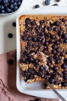 blueberry baked oatmeal in a white dish with spoon