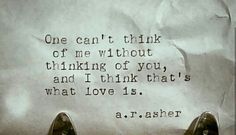 a pair of shoes sitting on top of a table next to a piece of paper that reads, one can't think of me without thinking of you, and i think of you, and i think that'd what love is