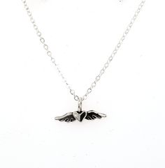 "This is a tiny tiny little heart with wings charm made out of solid sterling silver. It is perfect for layering with other necklaces, or wear it on it's own for a nice and simple necklace. It's perfect for a discrete and minimalist everyday necklace :) The photo on the neck form shows the charm on a 16\" chain, however you can chose between 16\", 18\", or 20\". I make all of my jewelry by hand in my Savannah, GA studio. Please contact me if you have any questions :)" Tiny Heart-shaped Sterling Silver Charm Necklaces, Tiny Sterling Silver Heart Pendant, Dainty Sterling Silver Open Heart Charm Necklace, Posey Ring, Stackable Name Rings, Heart Necklace Silver, Winged Heart, Mom Ring, Heart With Wings