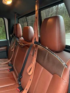 the interior of a car with brown leather seats and tan dash tape on the floor