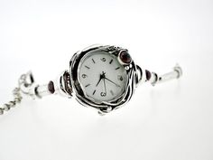 "From Porans watches collection ---> Unique sterling silver watch bracelet with3 Semi-precious stones of your choice. ( The photos are with Garnet) Face Dimensions: 1.12 inches. Size: I Can make any size you want. Please tell us your wrist size at \"message to seller\". Our watch is top quality stainless still, analog, Japanese movement with water resistance (up to 3 atmospheres) and it is powered by a battery that lasts about 3 years. The battery can be exchanged. Please notice that because Silver Analog Jewelry And Watches As Gift, Silver Jewelry And Watches With Bracelet Strap As Gift, Elegant Nickel-free Watches As Gifts, Futuristic Jewelry, Upcoming Fashion Trends, Linked Bracelet, Watches Collection, Watch For Women, Watch Bracelet