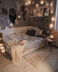 a bed room with a neatly made bed and lots of string lights on the wall