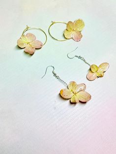 These Earrings are made out of real flowers. Each flower is carefully picked, dried and then coated in several layers of resin to preserve and protect the flowers. There is a choice between hoop or silver twist dangle earrings. The silver is recycled silver, attached to 925 silver ear wire hooks. Or gold plated hoops.  Our Jewellery is made with high-quality materials, with UV resin, yellowing resistant and water-resistant. Our hoops and Hooks are sourced from Jewellery making suppliers Or handm Cheap Flower-shaped Resin Earrings, Unique Flower-shaped Resin Earrings, Pink Flower-shaped Earrings With Pressed Flowers, Flower-shaped Resin Earrings With Pressed Flowers, Pink Resin Flower-shaped Earrings, Pink Hydrangea, Resin Flowers, Recycled Silver, Images Gif