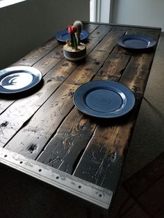 the table is made out of wood and has plates on it