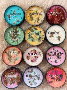 nine bowls with different types of pigments in them on a white surface, labeled zodiac signs and libra