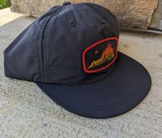 Our surf hat with the classic Virginia Sunset patch design. The hat is a lightweight recycled nylon material that dries faster and is good for the environment. One Size Fits Most. Lightweight Black Hat For Hiking, Nylon Six-panel Hiking Hats, Six-panel Nylon Hat For Hiking, Outdoor Flat Bill Dad Hat With Logo Patch, Outdoor Six-panel Dad Hat With Logo Patch, Outdoor Dad Hat With Logo Patch And Flat Bill, Six-panel Nylon Hiking Hat, Lightweight Six-panel Hat For Hiking, Flat Bill Dad Hat With Logo Patch For Outdoor