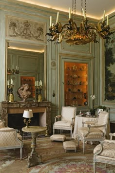 an ornate living room with chandelier and chairs