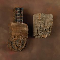 two wooden carvings with books on top of them and the words, product will vary