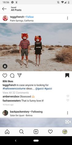 two people walking in the sand with one person wearing a bear mask on their head