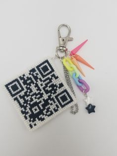 a key chain with a qr code on it and some scissors attached to it