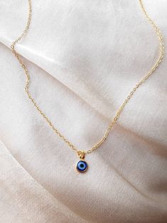 24K gold plated handmade necklace with a small blue evil eye pendant (For the baby blue evil eye necklace in the picture, check out this listing: https://www.etsy.com/uk/listing/1043552572/24k-gold-plated-small-baby-blue-evil-eye?ref=shop_home_active_2&frs=1) Chain length:17 inches (~42.5cm) Chain length may be shortened FREE of charge, please add the length you would like in the personalisation box below upon ordering or message me! Everything comes beautifully wrapped, with a small jewellery p Everyday Blue Tarnish-resistant Jewelry, Minimalist Handmade Gold Charm Necklace, Blue Pendant Charm Necklaces For Everyday, Blue Pendant Charm Necklace For Everyday, Everyday Blue Pendant Charm Necklaces, Dainty Blue Round Pendant Necklace, Blue Dainty Round Pendant Necklace, Handmade Gold Plated Charm Necklace For Everyday, Everyday Handmade Gold Plated Charm Necklaces