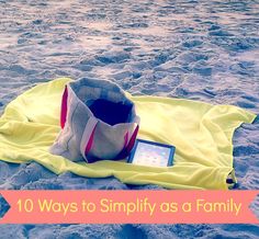 a blanket and hat on the beach with text overlay that reads 10 ways to simplily as a family