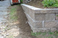 an image of a brick wall in the process of being built by someone's house