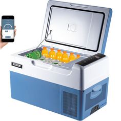 a person holding a cell phone next to an ice chest