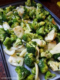 broccoli florets and onions on a baking sheet