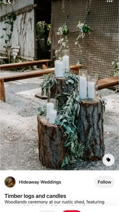 candles are placed on top of a tree stump in the middle of an outdoor area