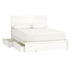 a white bed with two drawers underneath it