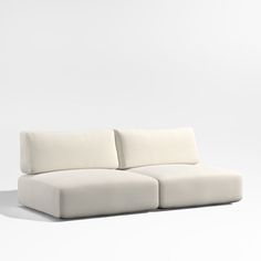 a white couch sitting on top of a white floor