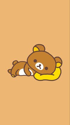 a brown teddy bear laying on top of a yellow pillow