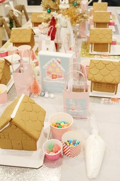 gingerbread houses and candy are on the table