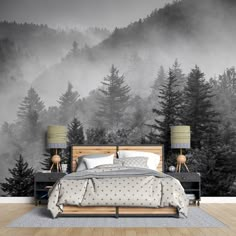 a bed room with a neatly made bed and a forest wall mural on the wall