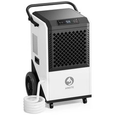 an electric air purifier sitting on top of a white table next to a hose