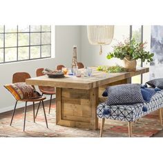 a dining room table with chairs around it and an area rug in front of the table